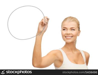 smiling woman in white shirt drawing round shape on glass