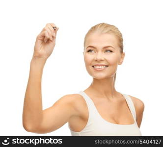 smiling woman in white shirt writing in the air