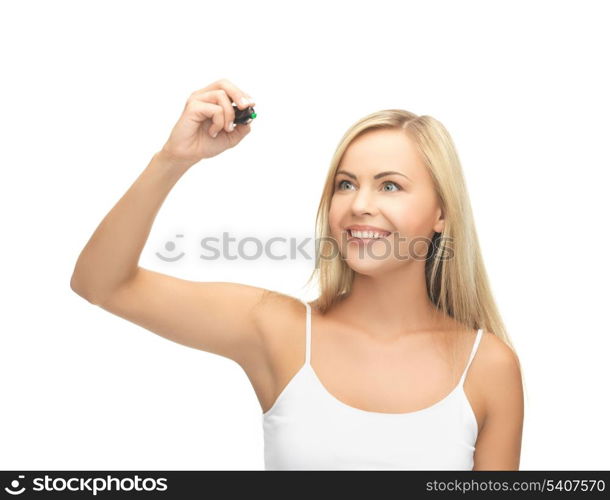 smiling woman in white shirt writing in the air