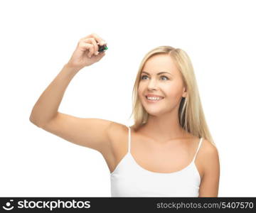 smiling woman in white shirt writing in the air