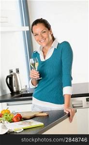 Smiling woman kitchen drinking wine preparing vegetables housewife