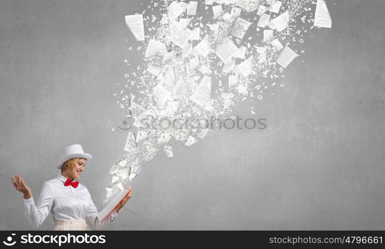 Smiling woman looking in book. Young woman in white hat with opened red book in hands