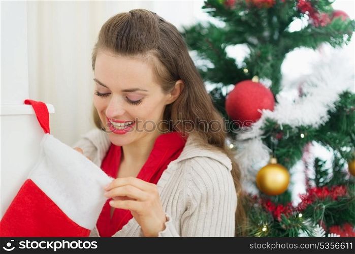 Smiling woman looking into Christmas socks