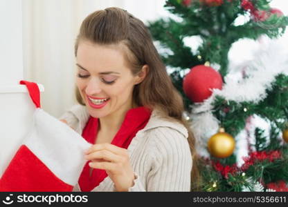 Smiling woman looking into Christmas socks