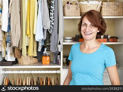 Smiling woman near closet
