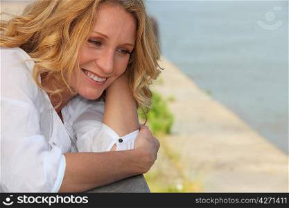 Smiling woman on a boardwalk