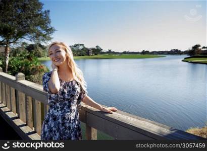 Smiling woman on the wooden bridge