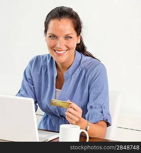 Smiling woman paying bills online banking home credit card consumerism