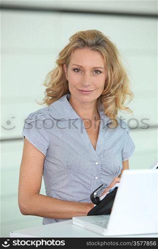 Smiling woman putting a date in her diary