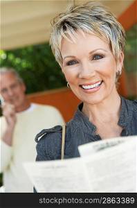 Smiling Woman Reading a Brochure
