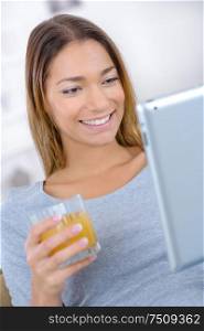 smiling woman reading on a tablet computer