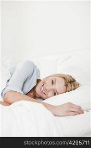 Smiling woman relaxing in bed