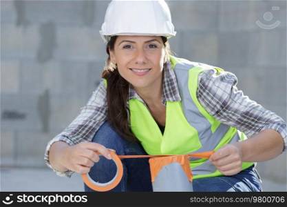 smiling woman repairer wearing coverall