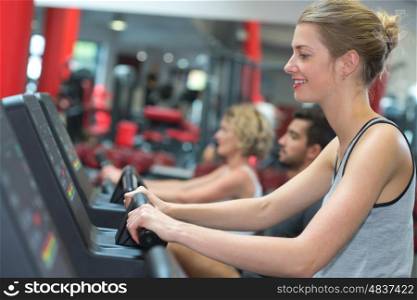 smiling woman running on a treadmill