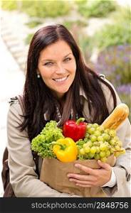 Smiling woman shopping vegetables groceries paper bag standing