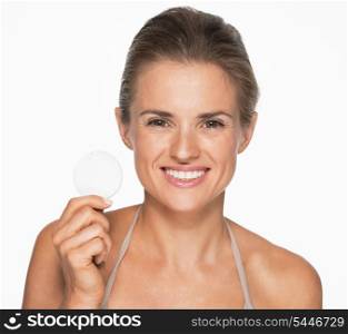 Smiling woman showing cotton pad