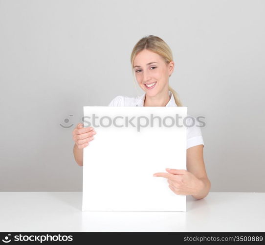 Smiling woman showing message board