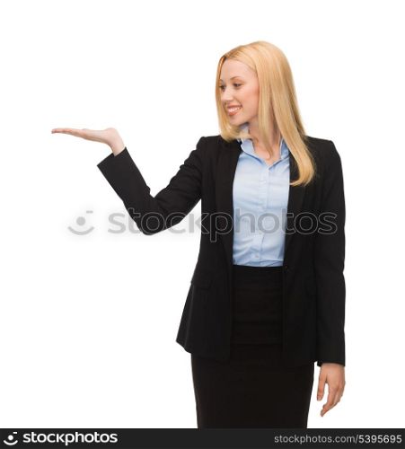 smiling woman showing something imaginary on her hand