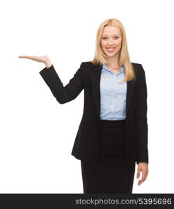 smiling woman showing something imaginary on her hand