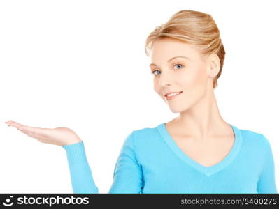 smiling woman showing something on the palm of her hand