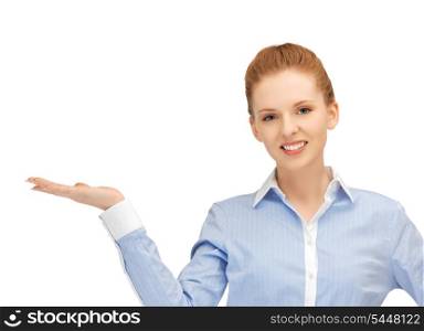 smiling woman showing something on the palm of her hand