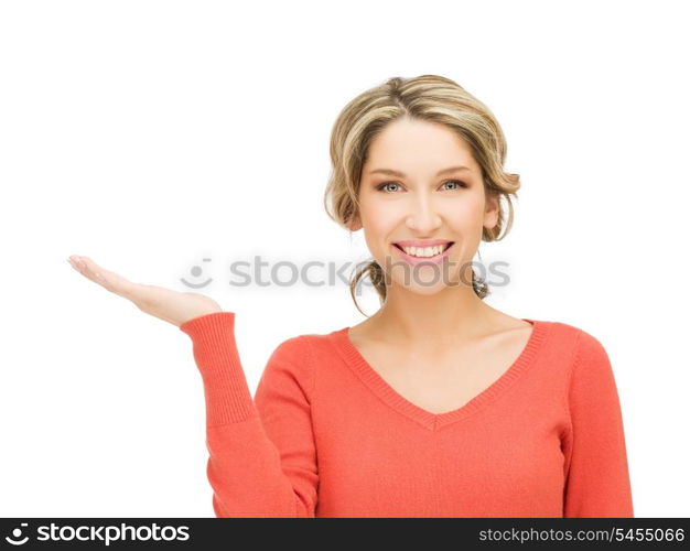 smiling woman showing something on the palm of her hand