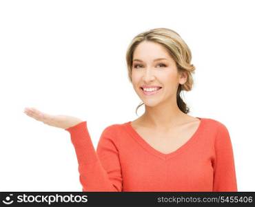 smiling woman showing something on the palm of her hand