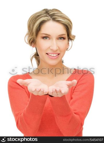 smiling woman showing something on the palms of her hands