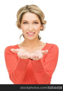 smiling woman showing something on the palms of her hands