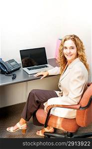 Smiling woman sitting at office desk