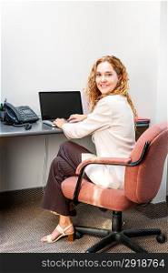 Smiling woman sitting at office desk