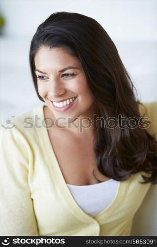 Smiling Woman Sitting On Sofa