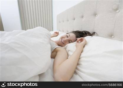 Smiling woman sleeping in bed