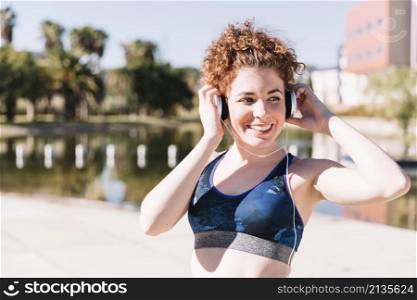 smiling woman sportswear enjoying music