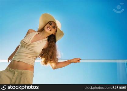 Smiling woman standing on balcony