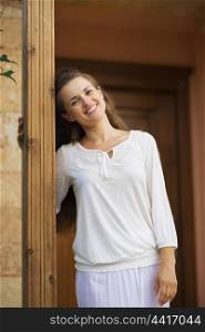 Smiling woman standing on doorstep