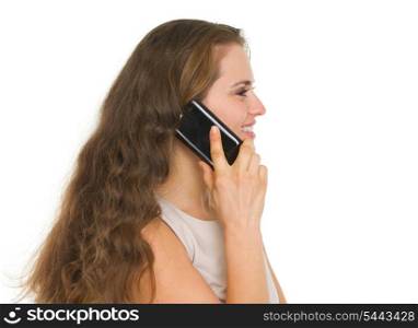 Smiling woman talking mobile phone. Side view