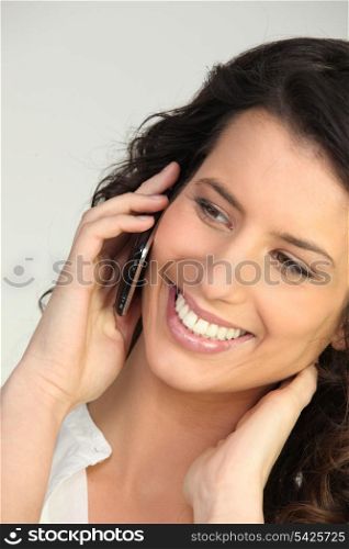 Smiling woman using a cellphone