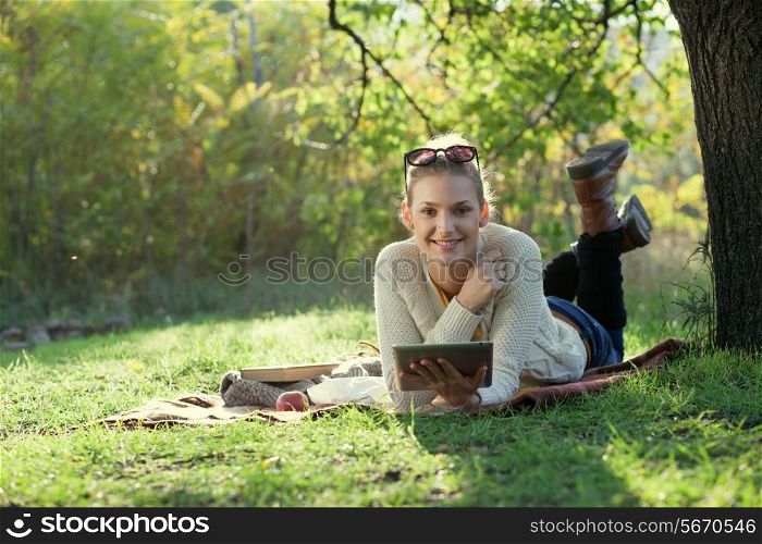 Smiling woman using computer outdoors
