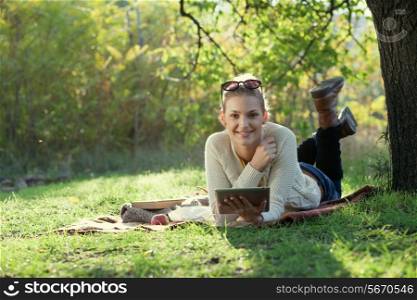 Smiling woman using computer outdoors