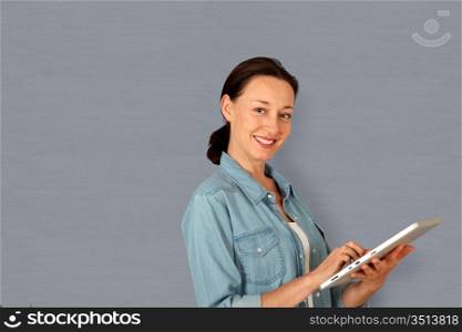Smiling woman using electronic tablet