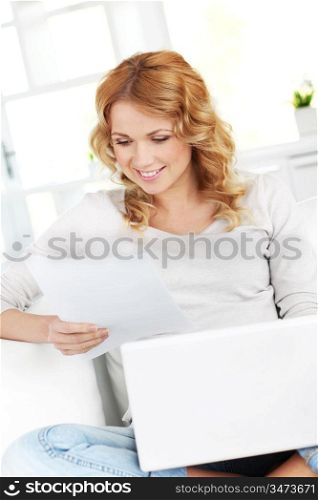 Smiling woman using laptop at home
