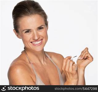 Smiling woman using nail polish