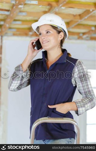 smiling woman using smart phone builder girl isolated portrait
