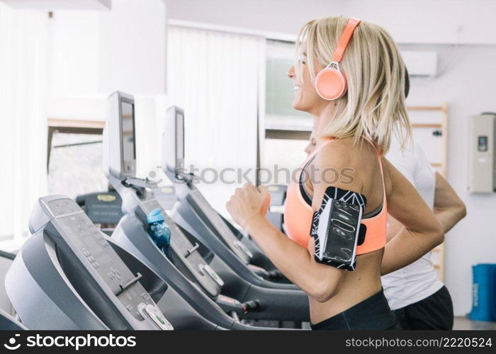 smiling woman using treadmill
