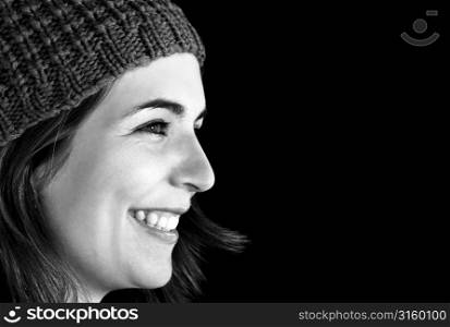 Smiling woman wearing hat in studio