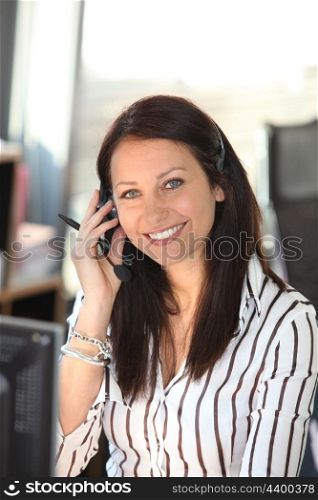 Smiling woman with a telephone headset