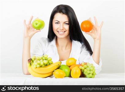 smiling woman with apple and orange in hands