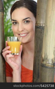 Smiling woman with glass of orange juice