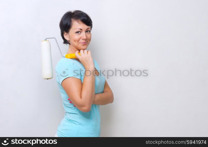 Smiling woman with painting roller